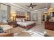 A stylish bedroom featuring a ceiling fan, carpet and elegant furnishings at 3543 Watermark Dr, Wesley Chapel, FL 33544