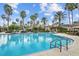 Sparkling community pool featuring crystal clear water, palm trees, and inviting lounge areas at 3543 Watermark Dr, Wesley Chapel, FL 33544