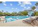 Community swimming pool showcasing its clear blue water, lane markers, and ample lounge chairs at 3543 Watermark Dr, Wesley Chapel, FL 33544