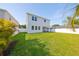 Large green backyard with a white fence surrounds the white two-story home at 3915 W Euclid Ave, Tampa, FL 33629