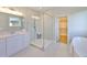 Modern bathroom with glass shower enclosure, sleek vanity, and a view into the walk-in closet at 3915 W Euclid Ave, Tampa, FL 33629