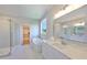 Elegant bathroom featuring a soaking tub, glass shower, and a spacious vanity with stone countertops at 3915 W Euclid Ave, Tampa, FL 33629