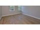 Spacious bedroom with hardwood floors and two windows providing natural light at 3915 W Euclid Ave, Tampa, FL 33629