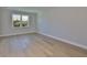 Bright bedroom featuring hardwood floors, natural light from the window, and neutral tones at 3915 W Euclid Ave, Tampa, FL 33629