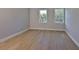 Bright bedroom with hardwood floors and two windows providing ample natural light at 3915 W Euclid Ave, Tampa, FL 33629