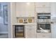 Modern kitchen featuring white cabinets, stainless steel appliances, and a built-in wine cooler at 3915 W Euclid Ave, Tampa, FL 33629