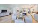 Open-concept living space with kitchen, dining area, and living room with modern furniture at 3915 W Euclid Ave, Tampa, FL 33629
