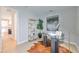 Well-lit home office featuring a glass desk, modern decor, and an open view to the kitchen at 3915 W Euclid Ave, Tampa, FL 33629