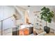 Bright home office with a glass desk, stylish shelving, and a view of the stairway at 3915 W Euclid Ave, Tampa, FL 33629