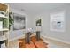 Stylish home office with a glass desk, unique rug, and ample natural light at 3915 W Euclid Ave, Tampa, FL 33629