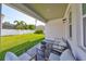 Covered patio with outdoor seating and a view of the landscaped backyard at 3915 W Euclid Ave, Tampa, FL 33629