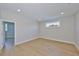 Open room featuring wood floors, neutral tones and natural light from the window at 3915 W Euclid Ave, Tampa, FL 33629