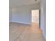 Open room featuring wood floors, with stairway entry and neutral tones at 3915 W Euclid Ave, Tampa, FL 33629