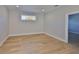 Open room featuring wood floors, neutral tones and natural light from the window at 3915 W Euclid Ave, Tampa, FL 33629