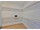 Spacious walk-in closet featuring custom shelving, hardwood floors and ample storage space at 3915 W Euclid Ave, Tampa, FL 33629