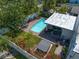 Aerial view of backyard featuring a pool, hot tub, lush landscaping, and patio at 409 Erie Ave, Tampa, FL 33606