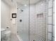 Modern bathroom features a glass shower, subway tile, and black and white patterned floor at 409 Erie Ave, Tampa, FL 33606
