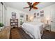 Bright bedroom with a ceiling fan, light colored walls, wood floors and a view to the exterior at 409 Erie Ave, Tampa, FL 33606
