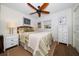 Cozy bedroom featuring a comfortable bed, a ceiling fan, and a neutral color palette with natural light at 409 Erie Ave, Tampa, FL 33606
