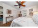 Bright bedroom with a ceiling fan, light colored walls, wood floors and access to the exterior at 409 Erie Ave, Tampa, FL 33606