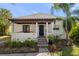 Charming home featuring a welcoming porch, steps with decorative tile and beautiful landscaping at 409 Erie Ave, Tampa, FL 33606
