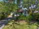Charming home with mature trees, green grass, and lush landscaping, creating a sense of privacy at 409 Erie Ave, Tampa, FL 33606