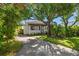 Charming home with a red tile roof, a well-manicured lawn, and mature trees, creating a welcoming curb appeal at 409 Erie Ave, Tampa, FL 33606