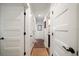 Bright hallway featuring a hardwood floor and multiple white doors with black hardware at 409 Erie Ave, Tampa, FL 33606