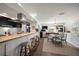 Open kitchen bar with seating overlooks the dining area with stylish decor and stainless appliances at 409 Erie Ave, Tampa, FL 33606