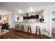 Open kitchen bar with seating overlooks the living area and features modern stainless steel appliances and granite countertops at 409 Erie Ave, Tampa, FL 33606