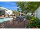 Backyard with sparkling pool, patio seating, and lush tropical landscaping at 409 Erie Ave, Tampa, FL 33606