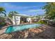 Private backyard pool with covered patio seating and lush landscaping at 409 Erie Ave, Tampa, FL 33606