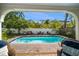 Inviting backyard pool area with brick patio, white fence, and lush greenery at 409 Erie Ave, Tampa, FL 33606