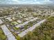Aerial view of a well-maintained neighborhood featuring tidy single-story homes, carports and some with a community pool at 4235 Richmere Dr # 4235, New Port Richey, FL 34652