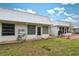 Grassy backyard showing well maintained lawn, exterior outlets, and a patio space for outdoor gatherings at 4235 Richmere Dr # 4235, New Port Richey, FL 34652