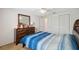Cozy bedroom featuring a queen-size bed and closet with a dresser and bright mirror at 4235 Richmere Dr # 4235, New Port Richey, FL 34652