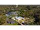 Aerial view of the property, showcasing the house, yard, surrounding trees and neighborhood at 4509 26Th S Ave, Tampa, FL 33619