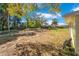 View of the spacious backyard featuring mature trees and partially cleared areas at 4509 26Th S Ave, Tampa, FL 33619