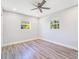 This bedroom features new gray flooring and natural light from the windows at 4509 26Th S Ave, Tampa, FL 33619