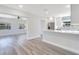 Modern kitchen with white cabinets, stainless steel appliances, and gray wood flooring at 4509 26Th S Ave, Tampa, FL 33619