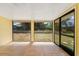 Bright sunroom with tile flooring and screened windows overlooking the backyard at 4509 26Th S Ave, Tampa, FL 33619