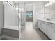Stylish bathroom features a large glass enclosed shower with seat and double sink vanity with modern lighting at 4597 Blue Star Ct, North Port, FL 34289