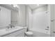 Bright, all-white bathroom with modern fixtures and shower-tub combo at 4597 Blue Star Ct, North Port, FL 34289