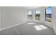 Vacant bedroom with plush carpeting and bright windows providing ample natural light at 4597 Blue Star Ct, North Port, FL 34289