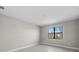 Neutral bedroom with tiled floors and a large window at 4597 Blue Star Ct, North Port, FL 34289