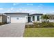 Charming single-story home with a well-manicured lawn and a two-car garage at 4597 Blue Star Ct, North Port, FL 34289