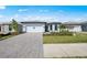 Beautiful single-story home featuring a brick driveway and lush green landscaping at 4597 Blue Star Ct, North Port, FL 34289