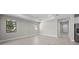 Bright, neutral living room with tiled floors and large windows at 4597 Blue Star Ct, North Port, FL 34289