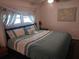 Comfortable bedroom featuring a queen-size bed, soft bedding, and natural light from the window at 46 Washington Ct # 28, Palm Harbor, FL 34684