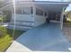 Charming home exterior with carport, well-maintained lawn, and landscaped flower beds at 46 Washington Ct # 28, Palm Harbor, FL 34684